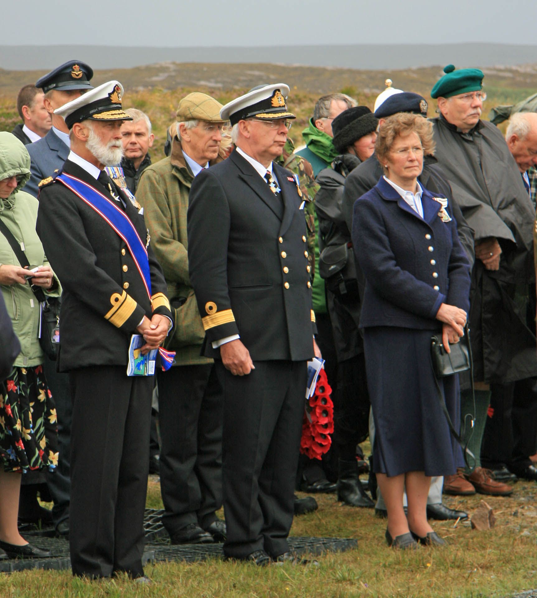 A picture of a parade of veterans and service personnel at the Arctic Convoy Monument Aultbea, Gairloch.
