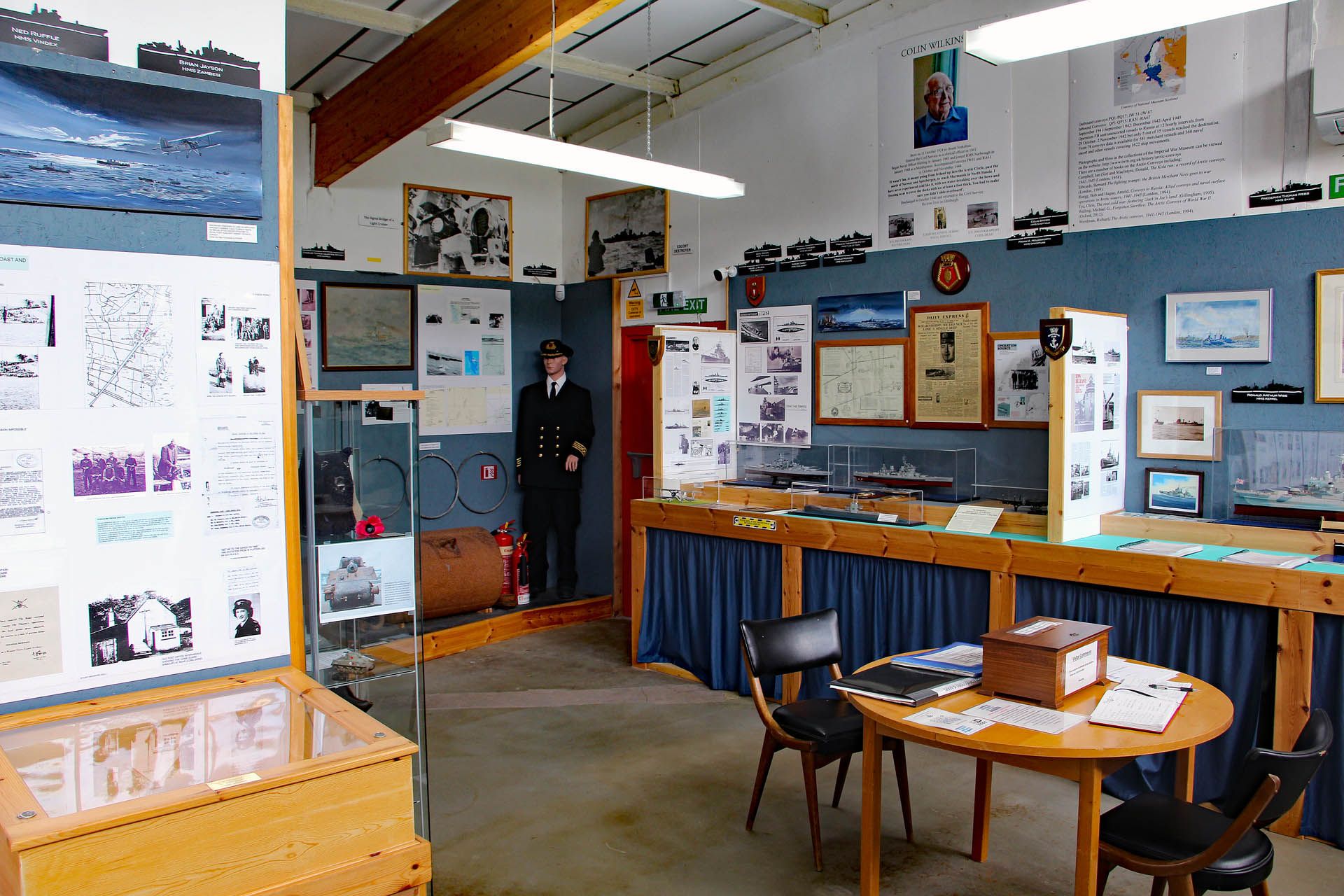 A picture of an exhibition within the Arctic Convoy Museum Aultbea, Gairloch. The picture features artifacts and pictures relating to wartime events.