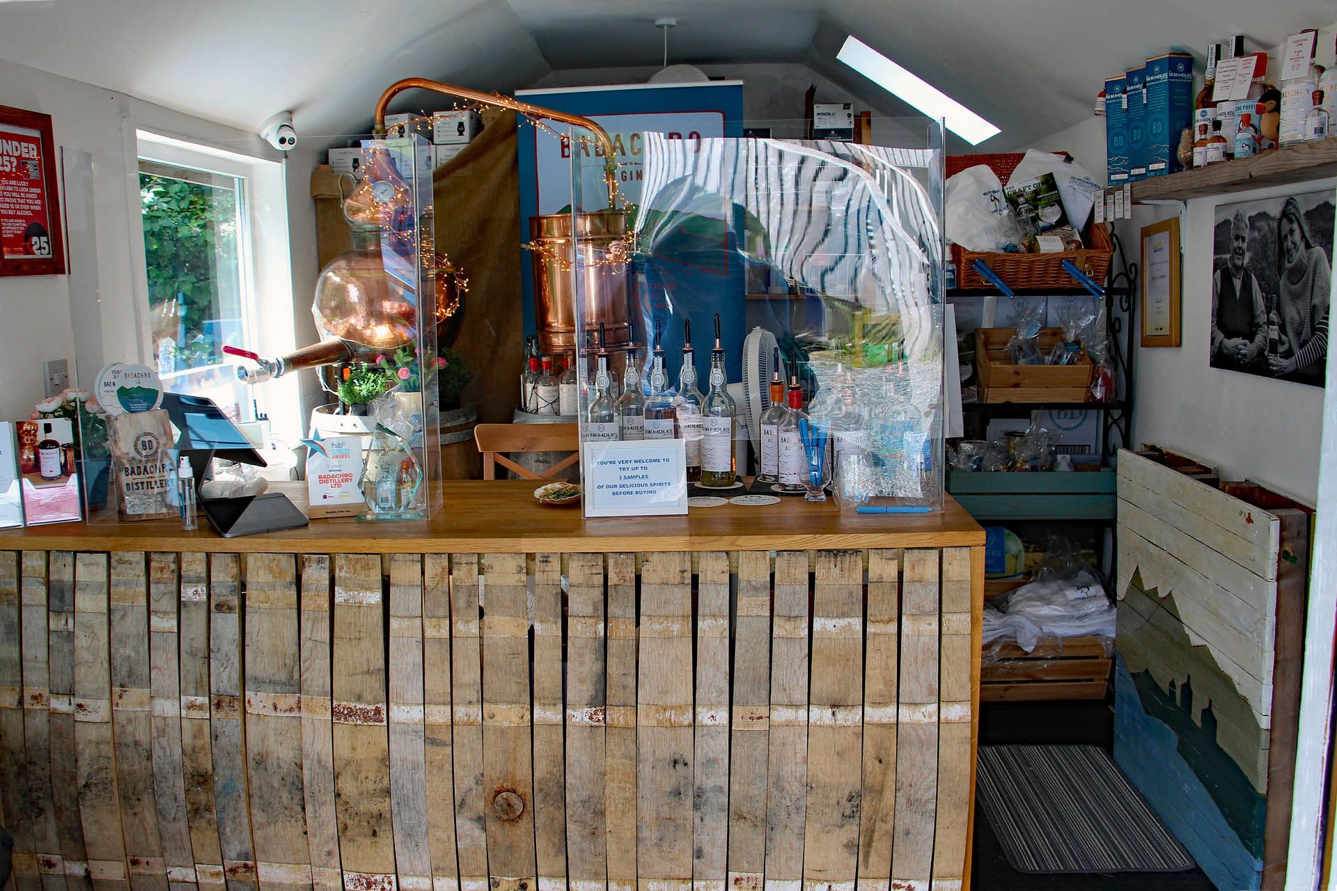 A picture of the inside of the Badachro Distillery shop in Gairloch, displaying gifts you can purchase