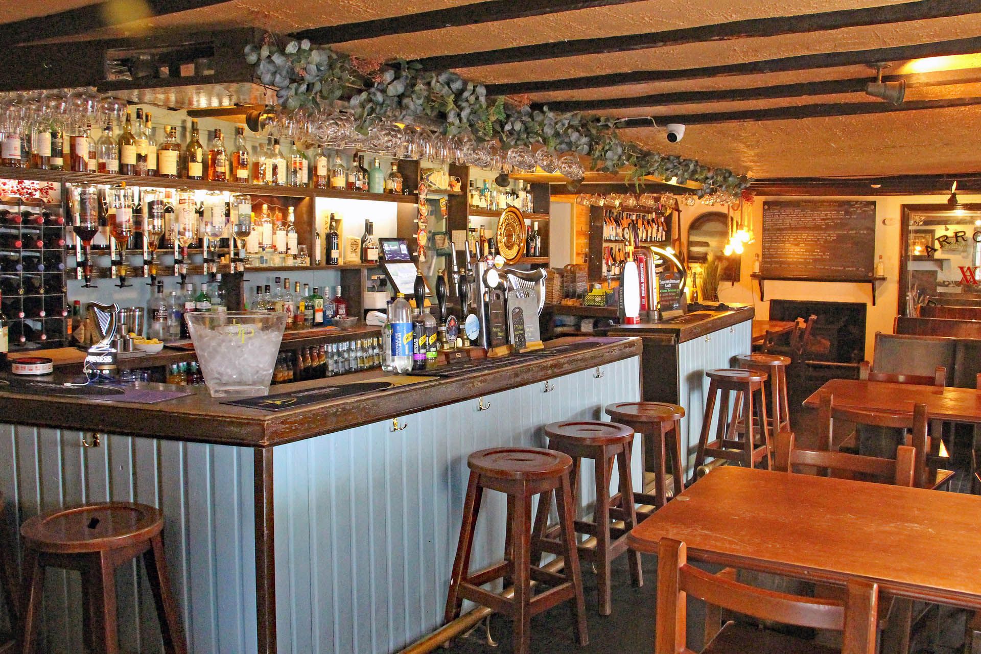 A picture of the bar area within the Badachro Inn in Gairloch. The picture includes a selection of drinks available.