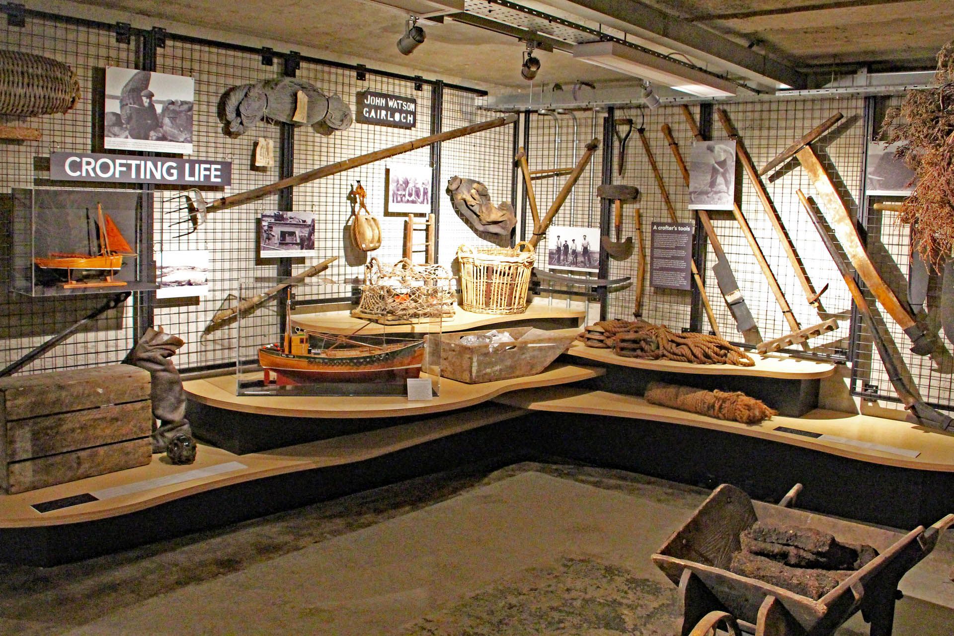 A picture of an exhibition within the Gairloch Museum. The picture features boating equipment, tools and models