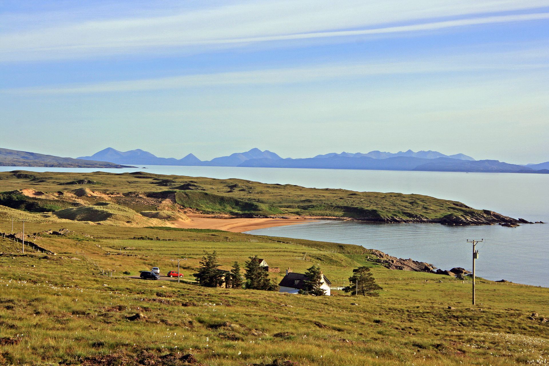 Picture of Red Point and Red Point Beach from the road to the north, looking across the MInch to the Cuillin Hills on the Isle of Skye